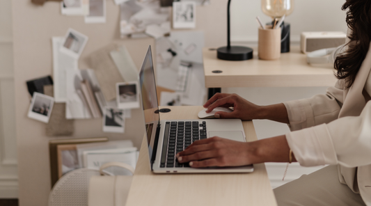 interior design business owner in studio working on a laptop
