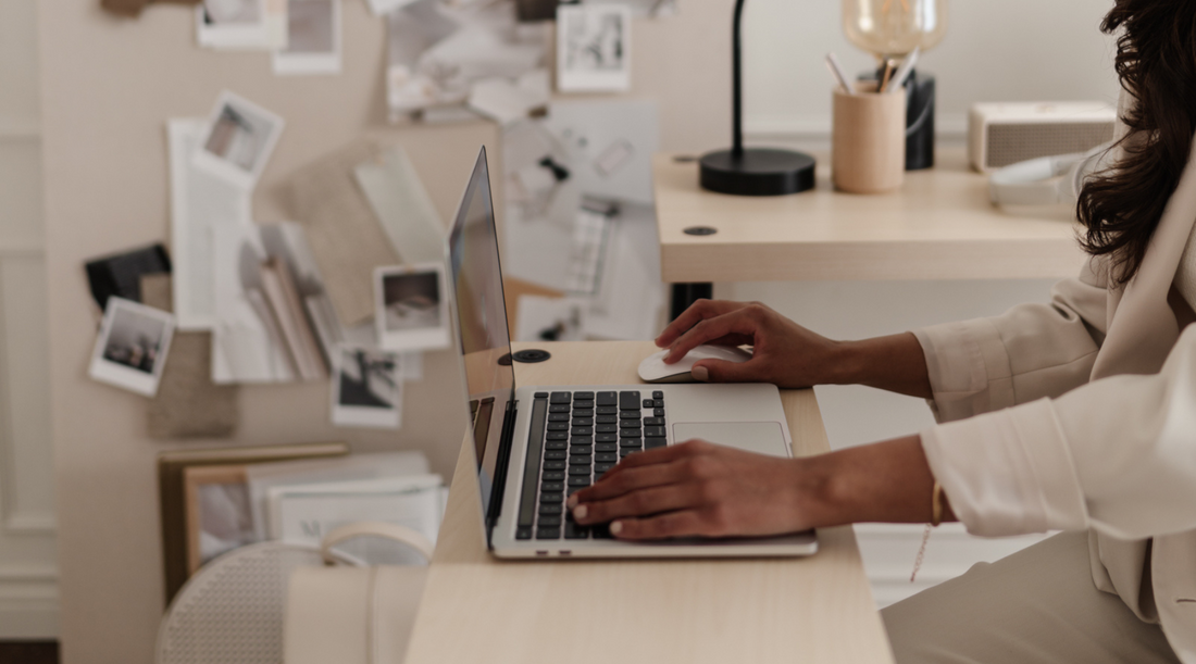 interior design business owner in studio working on a laptop